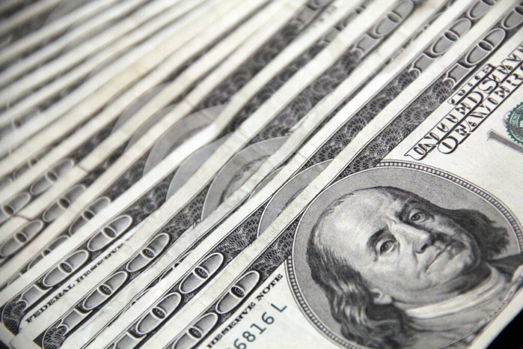 A bunch of 100 dollar bills in a row