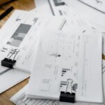 A massive pile of papers with graphs and notes on them