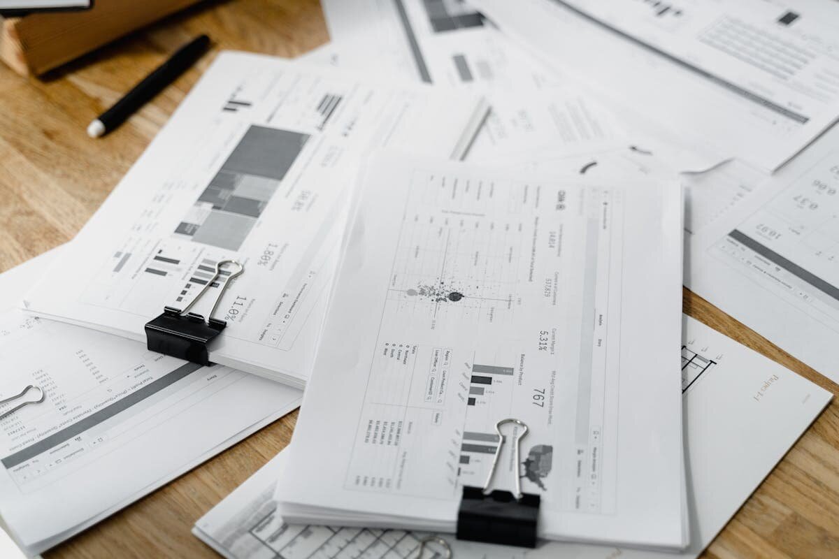 A massive pile of papers with graphs and notes on them