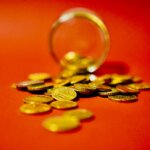 A bunch of non-american coins all spilled out on the ground