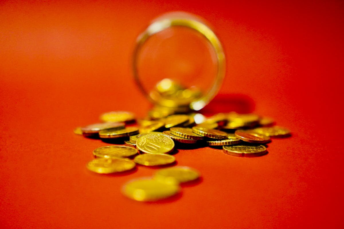 A bunch of non-american coins all spilled out on the ground