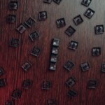 A bunch of keyboard keys on a desk that spells out scam