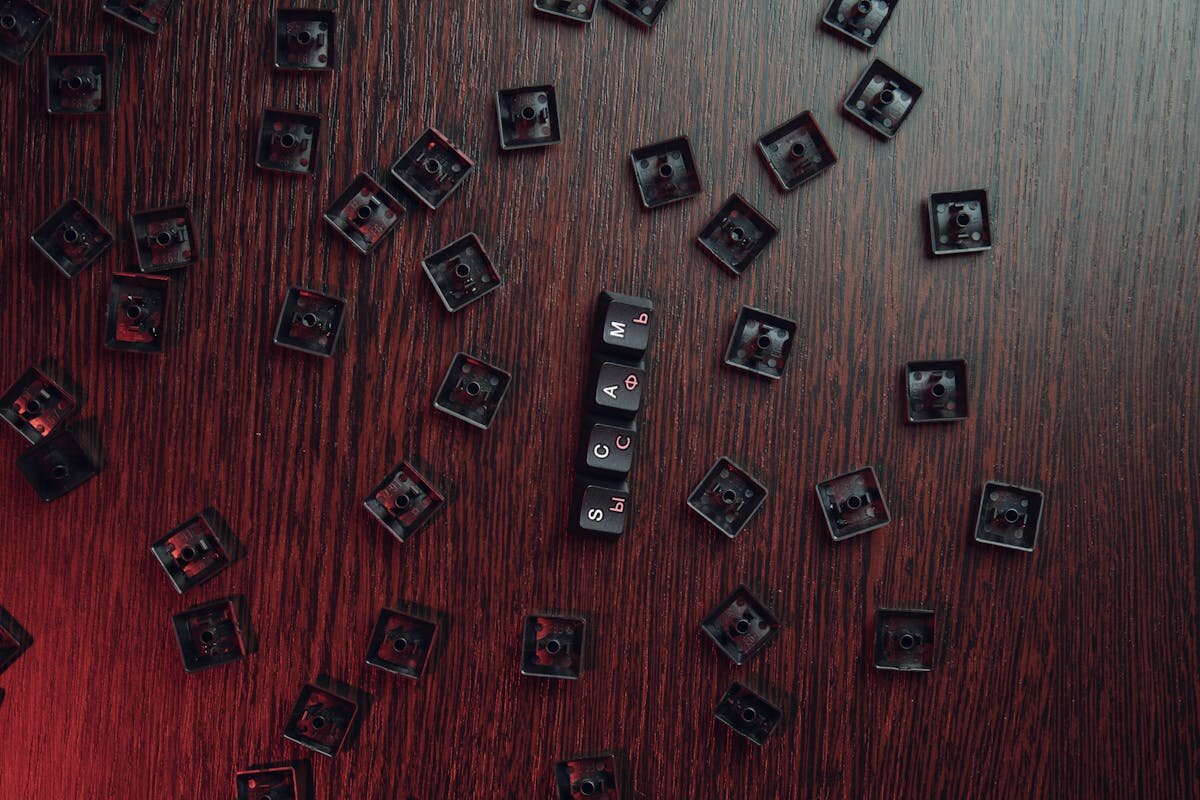 A bunch of keyboard keys on a desk that spells out scam
