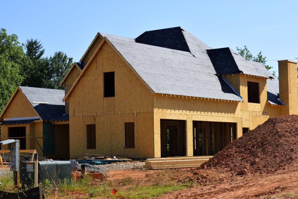 A house being built with a bunch of dirt around it