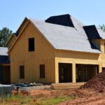 A house being built with a bunch of dirt around it
