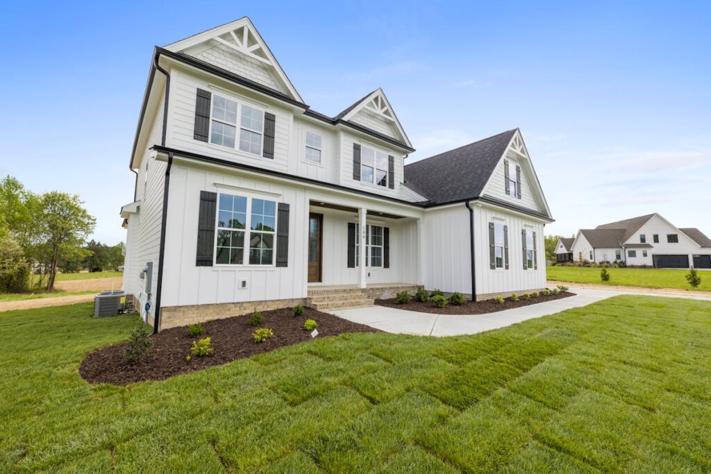 A white house with a well-kept yard