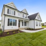 A white house with a well-kept yard