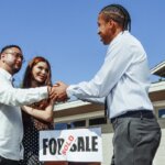 A person shaking the hands of a home buyer