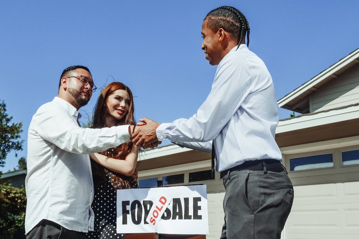 A person shaking the hands of a home buyer