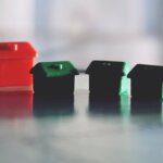 A bunch of small monopoly houses sitting on a table