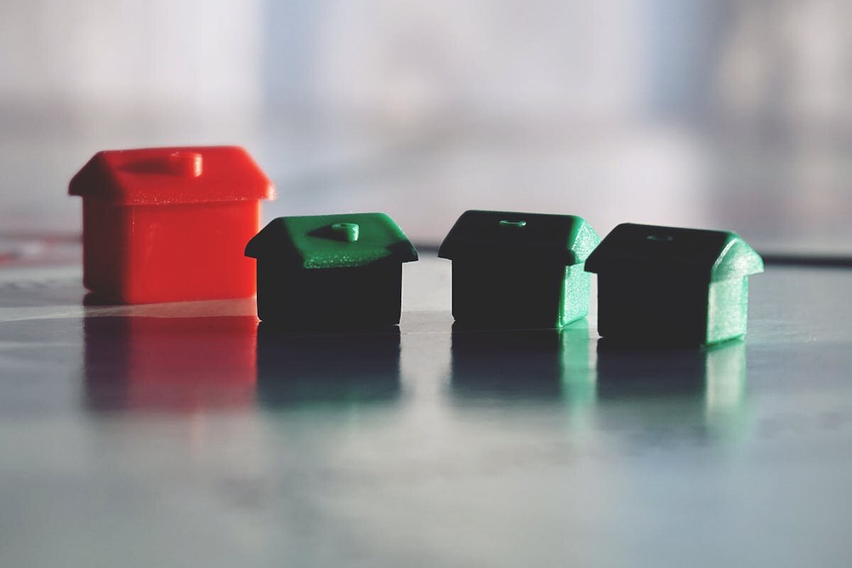 A bunch of small monopoly houses sitting on a table