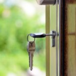A key sitting inside the lock of a house door