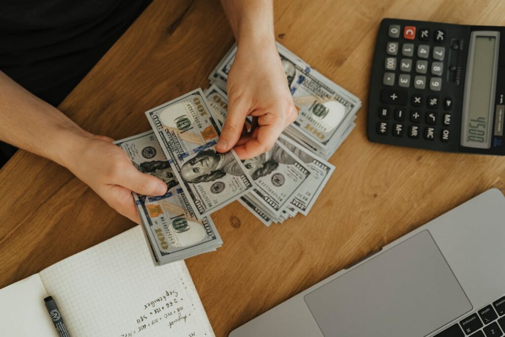 A person counting money on a table
