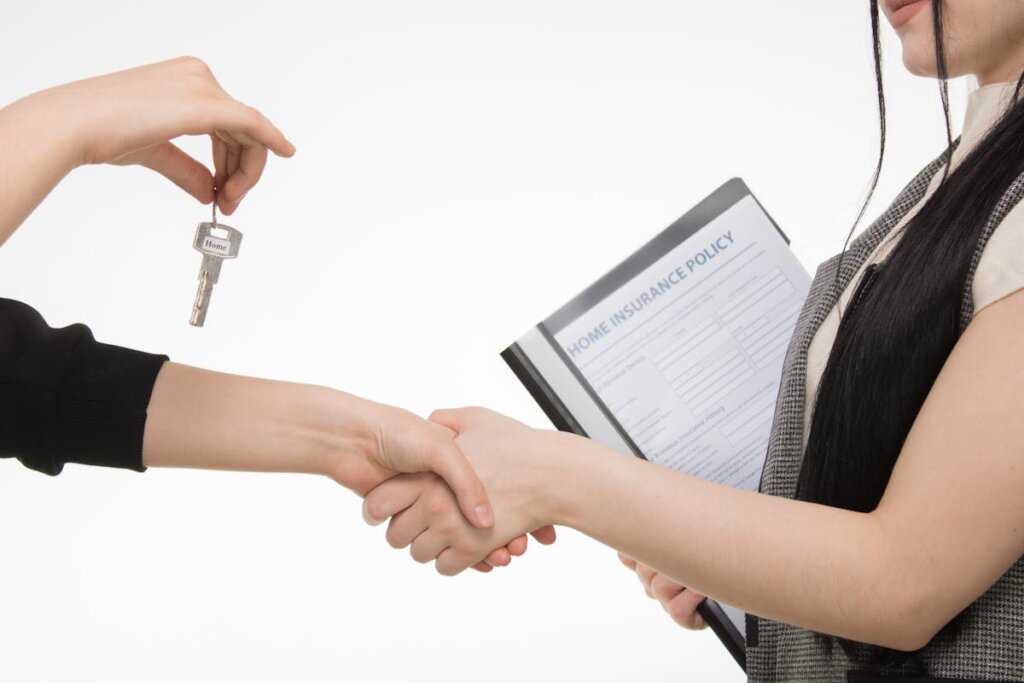 A house seller shaking a house buyer's hand after a sale