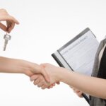 A house seller shaking a house buyer's hand after a sale