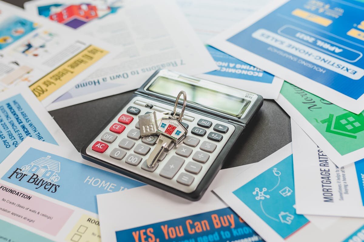 A bunch of papers with a calculator on top