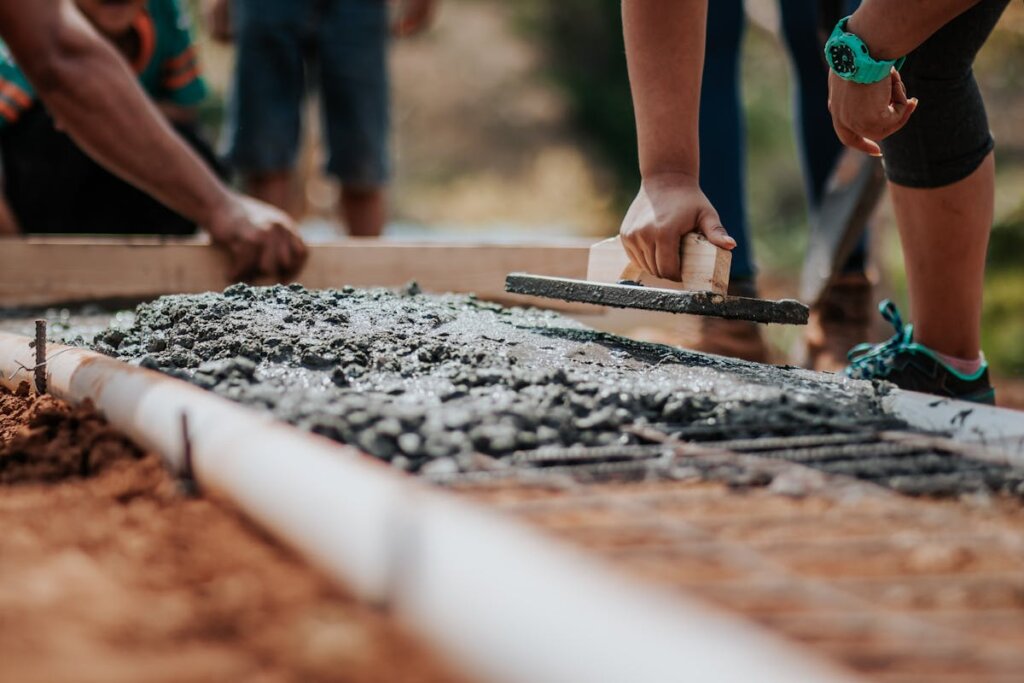 A bunch of people creating a foundation for a house