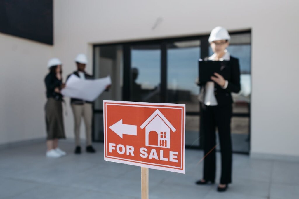 A bunch of workers looking at a house for sale