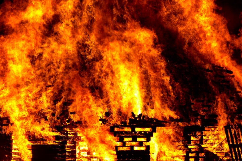 A house that is on fire and absolutely destroyed