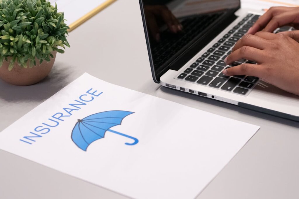 A person next to a paper that has insurance on it