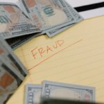 A bunch of hundred dollar bills with the word fraud in the middle