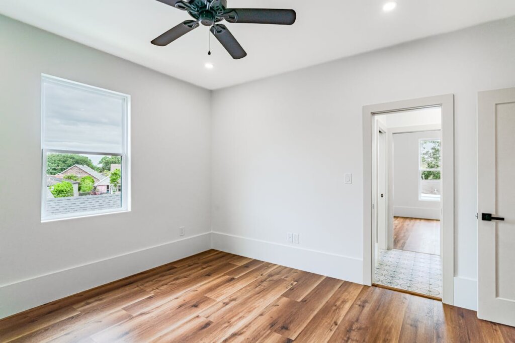 An empty room with a ceiling fan