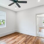 An empty room with a ceiling fan
