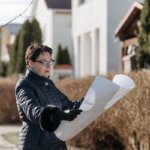 A lady looking at the blueprints of a home