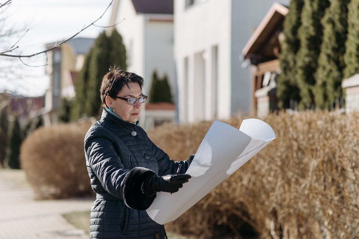 A lady looking at the blueprints of a home