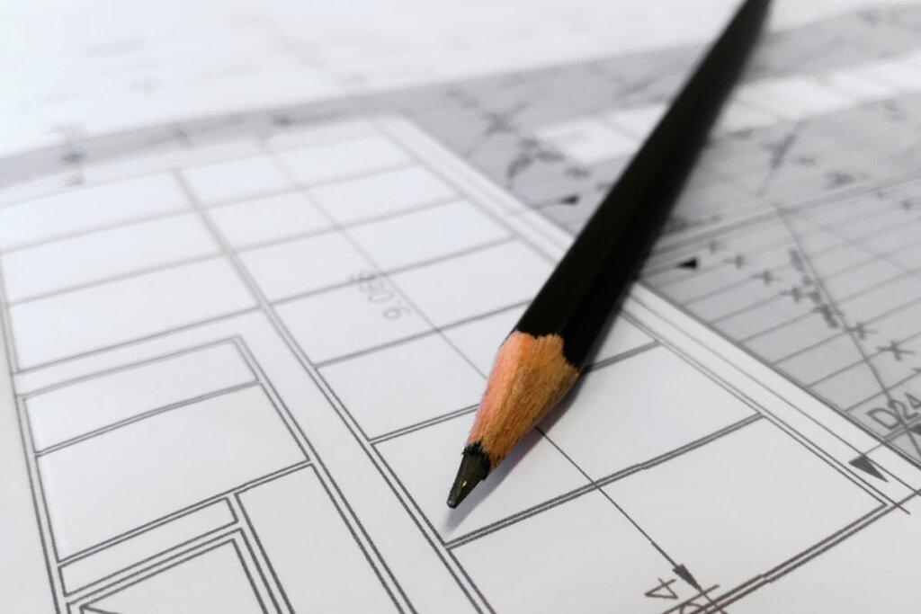 A blueprint of a house with a pencil on top of it
