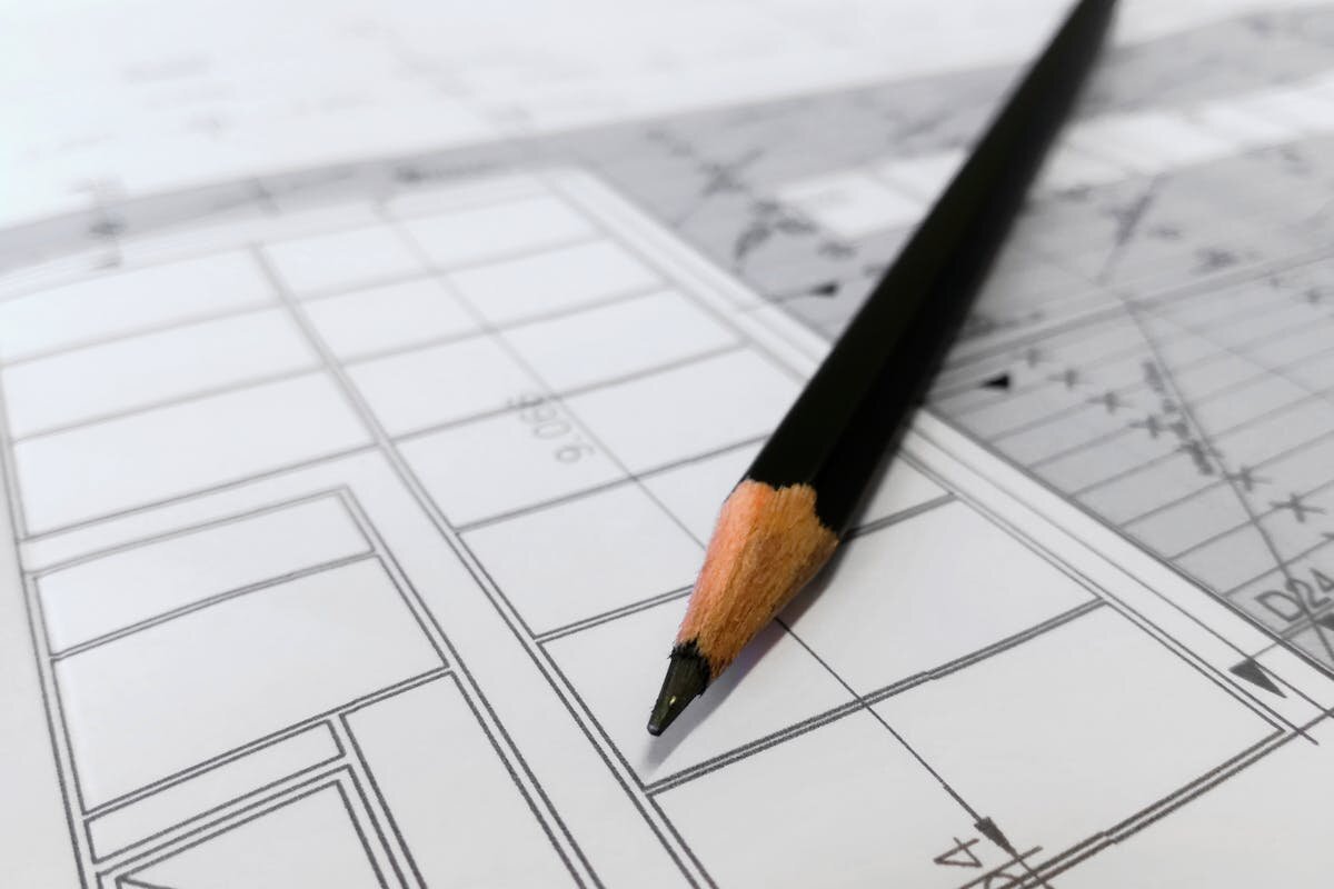 A blueprint of a house with a pencil on top of it