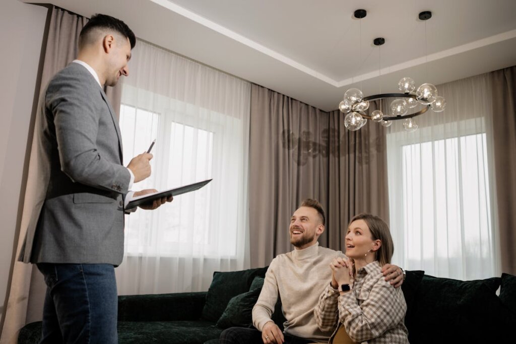 A real estate agent talking with a family in a room