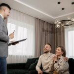 A real estate agent talking with a family in a room