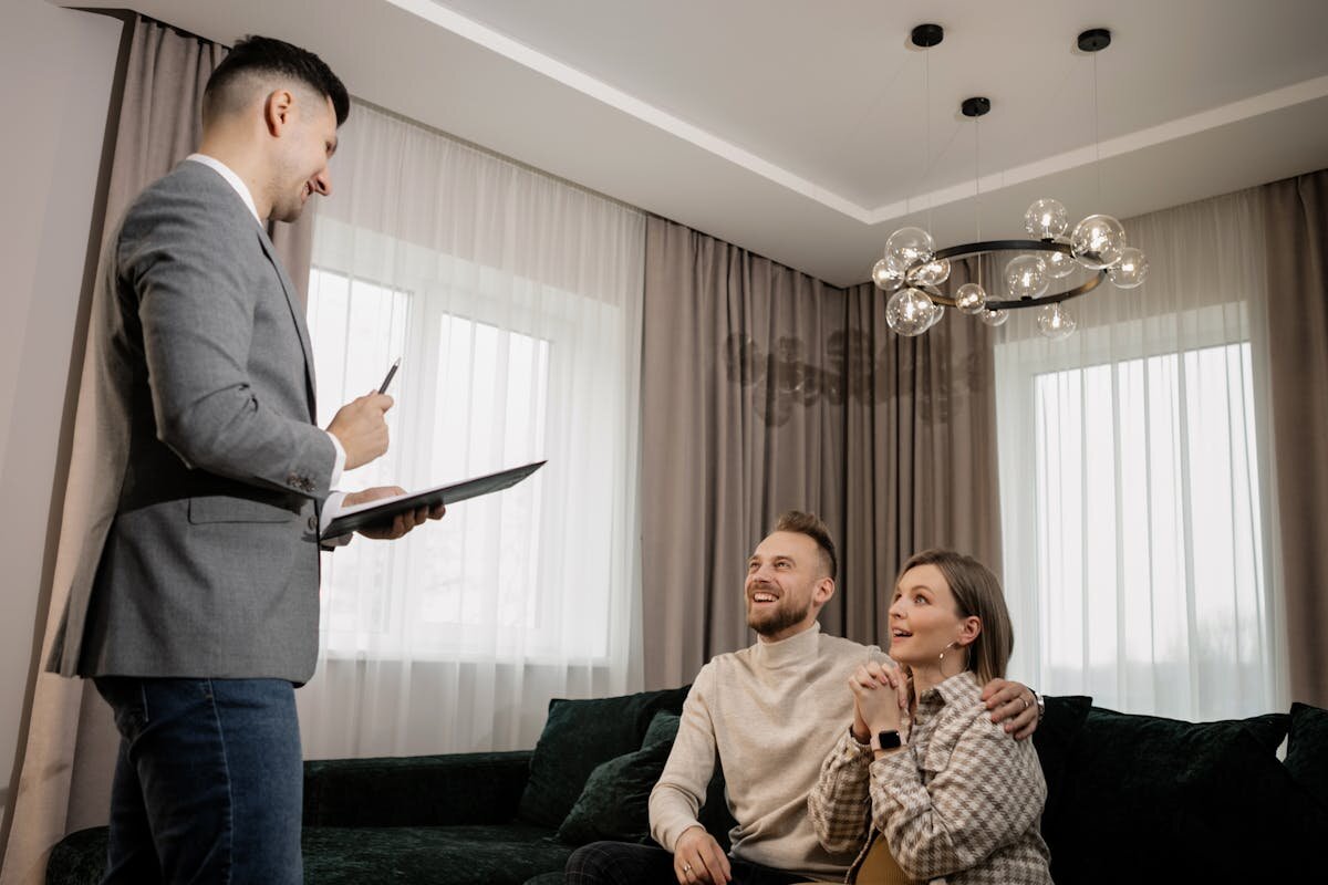 A real estate agent talking with a family in a room