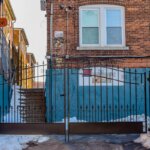 A gate blocking off a section of alleyway