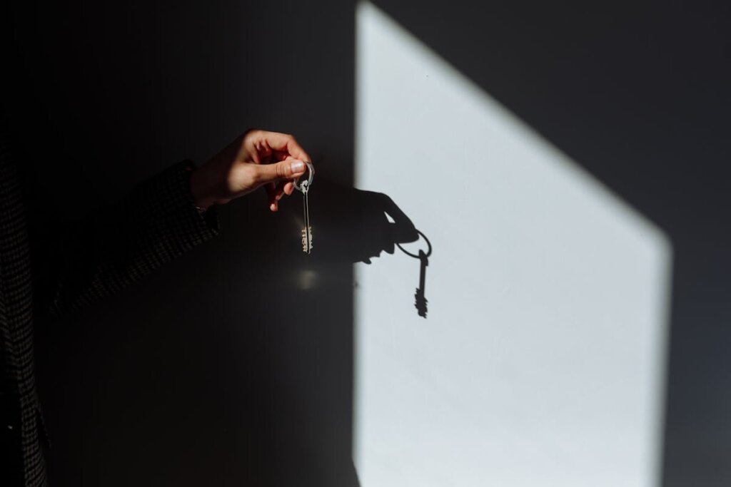 A person holding a key up to the sun