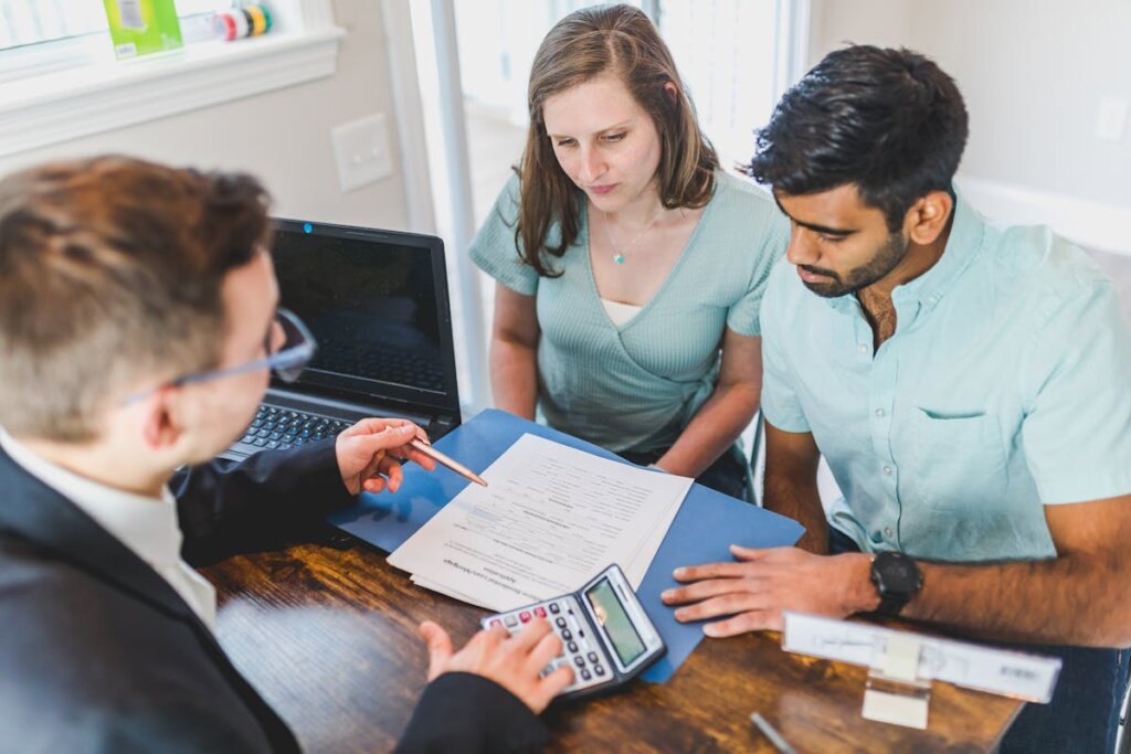 A realtor giving papers to some buyers