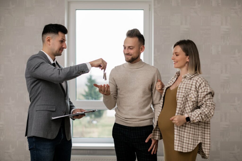 A realtor giving keys to some house buyers