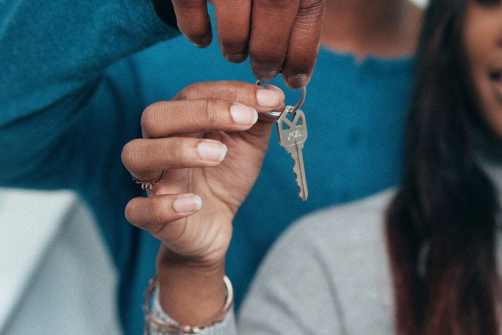 A couple people holding a key on a keychain