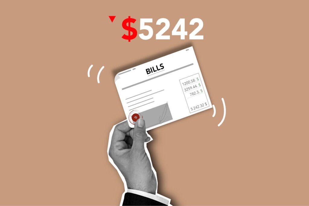 A hand holding a bill that needs to be paid