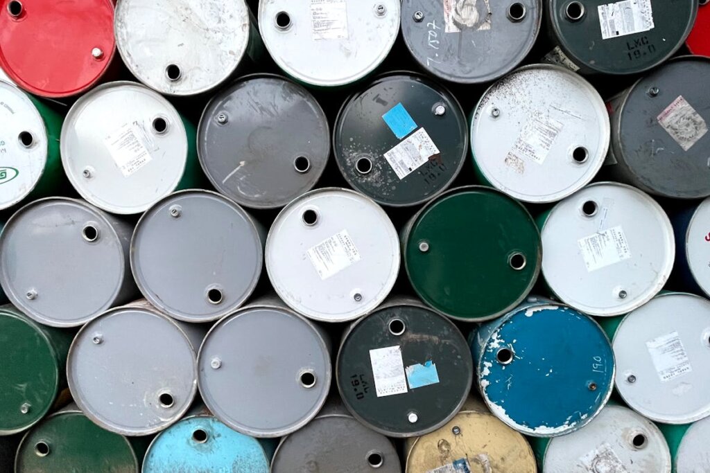 A bunch of oil barrels sitting side by side