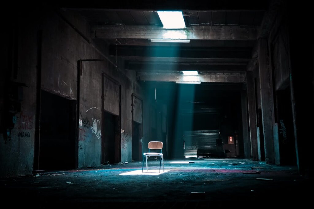 A vacant property with a chair in the middle of the room