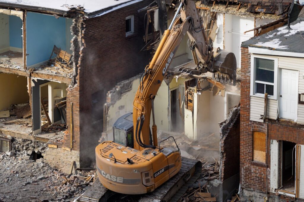 A house being destroyed with a construction machine