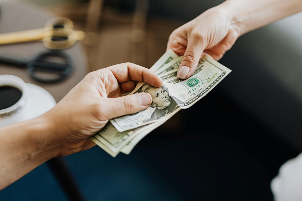 man handing cash to girl