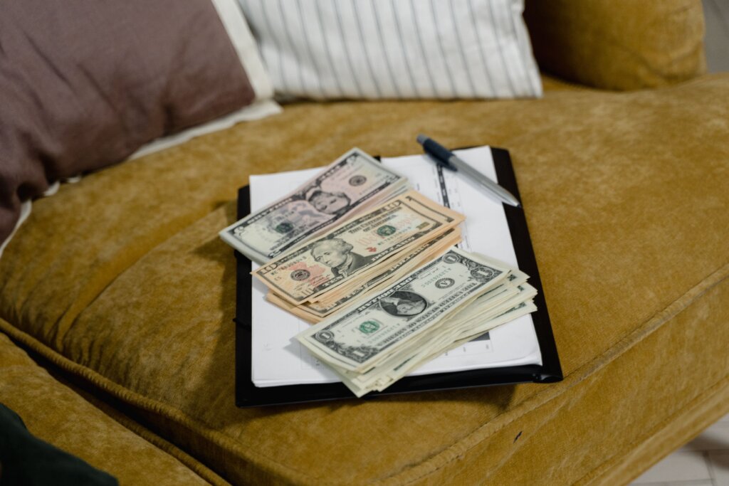 cash on a paper on a couch