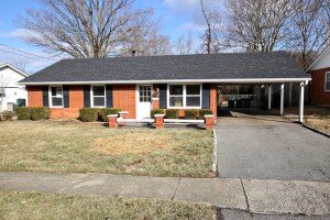 Orange Brick Range with white door and black shutters.