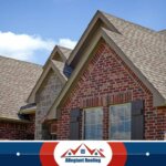 A house with a shingled roof, showcasing the craftsmanship of a roofing company in Dayton, OH.