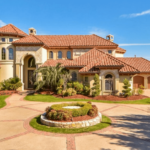 A beautiful home with a large driveway and an eye-catching roof color.