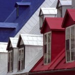 A row of houses with **metal** roofs.