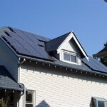 A house with solar panels on the roof undergoing spring cleaning.